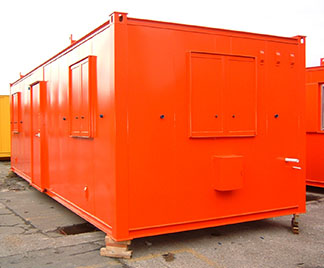 An orange shipping container with a door and windows