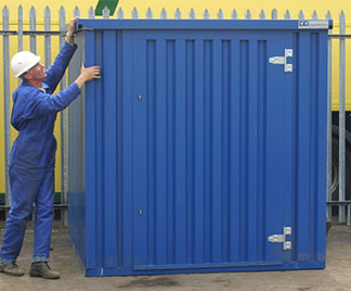 A blue sectional steel unit getting assembled by a worker