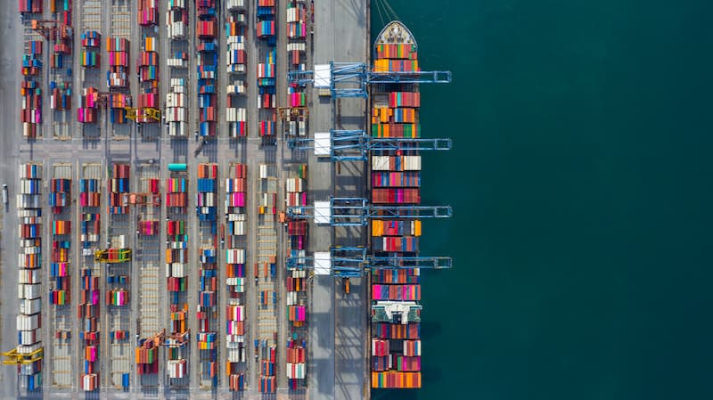 Port loading containers on ship birds eye view