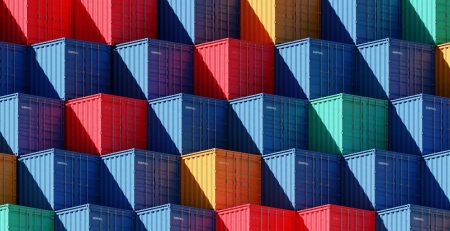 A series of multi-coloured shipping containers lined up in a pattern, two blue, red, two blue