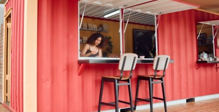 Woman working in a steel container that's been renovated into a coffee shop